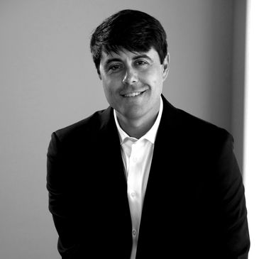 Smiling man in a suit.