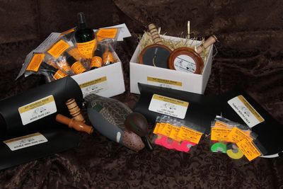 A collection of duck hunting decoys and accessories arranged on a dark fabric.