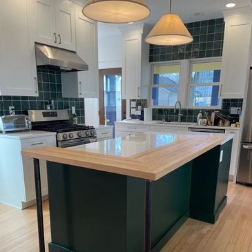 Remodeled kitchen, with center island and raised counter surround.