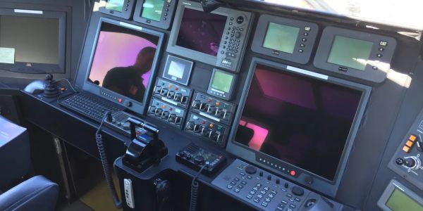 Control panel with multiple screens and controls.