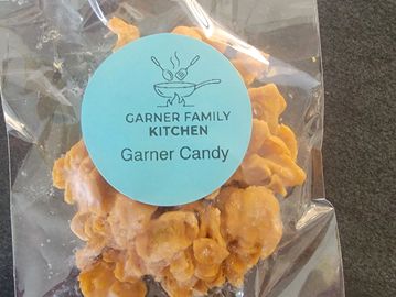 A clear bag of orange Garner Candy from Garner Family Kitchen.