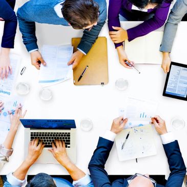 Image of view from abofe of people at a board meeting.