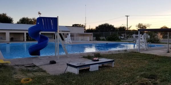 An Interpool pool project with a blue water slide and completed swimming pool.