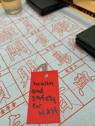 red wish card in front of chinese characters 