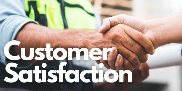 A man wearing PPE shakes the hand of a customer and smiles