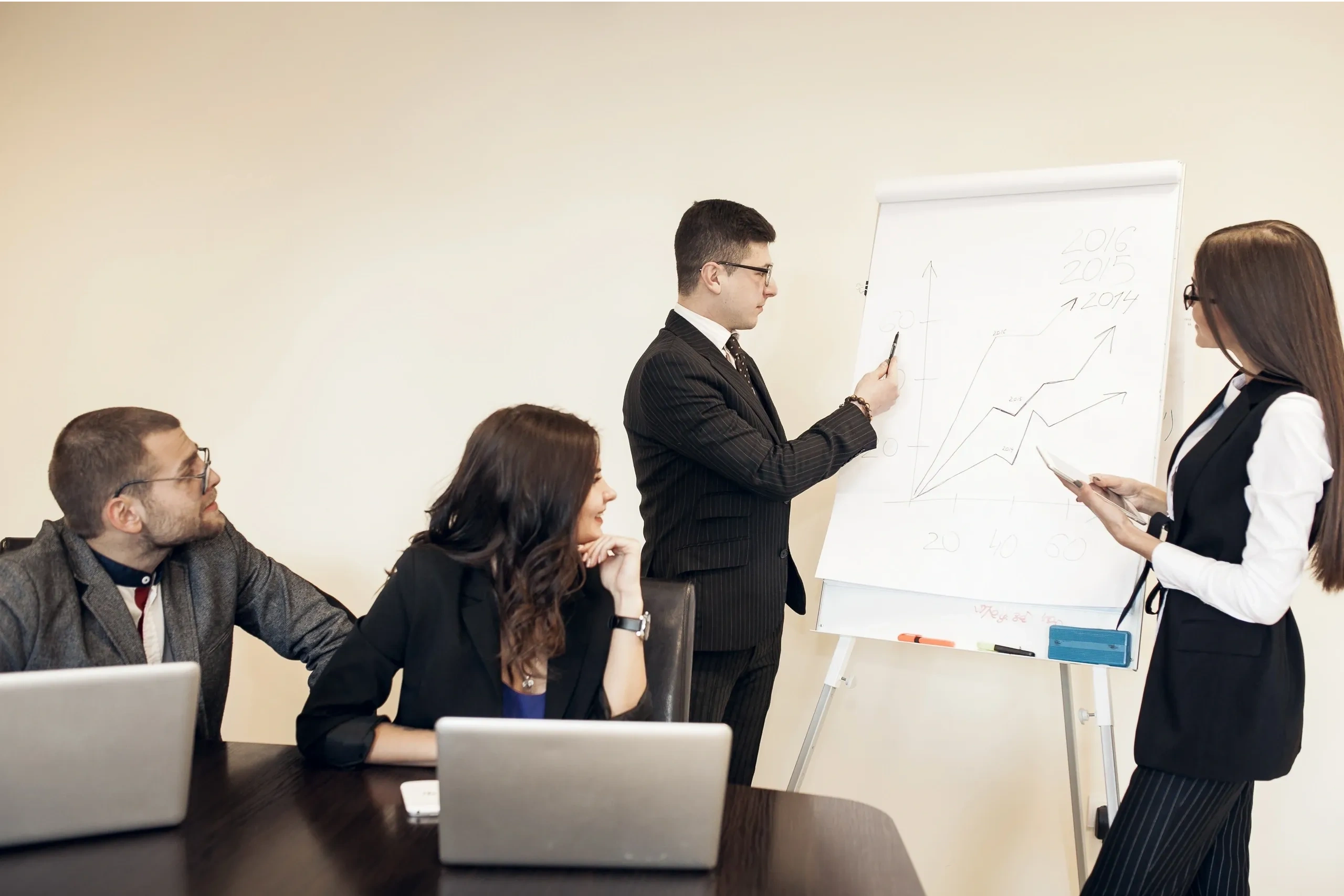 Business team discussing growth chart in a meeting room.