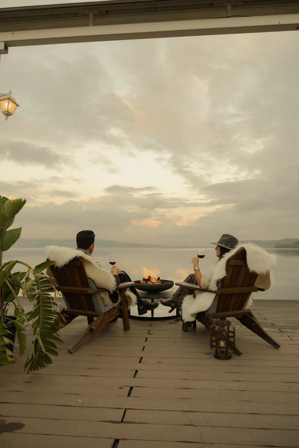 sapanca gölü kıyısında iskelede göl manzarasında temiz hava eşliğinde şarap içen çift 