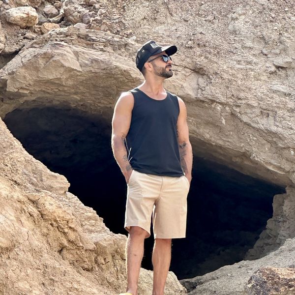 Ryan standing confidently in front of a rock formation.