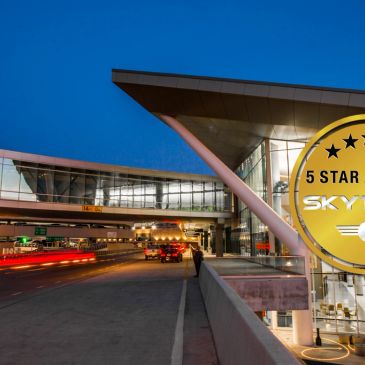 Modern airport terminal at twilight with a 5-star Skytrax award.
