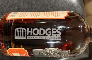Liquor bottle with company logo engraved on the side