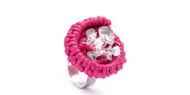 fuchsia cord and silver flowers with blue topaz. A bold, handmade statement ring crafted in London.