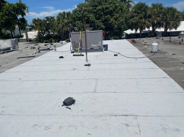 After some spot treatment, we torched down new modified bitumen roofing paper over the entire unit.