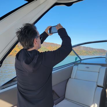 Person taking photo on boat.