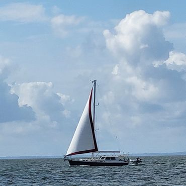 White sailboat on open water.