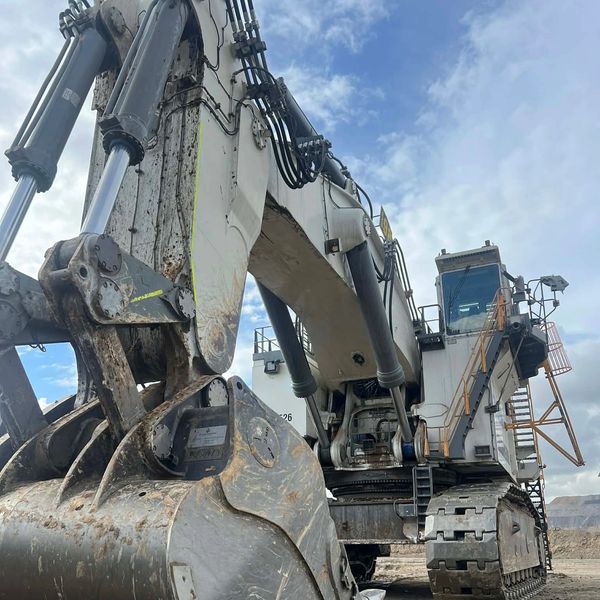 Close-up of a large excavator bucket and arm.
