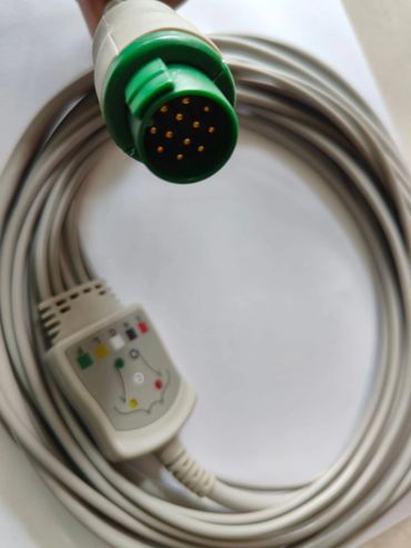 Close-up of a gray cable with a green 10-pin connector and a labeled adapter.