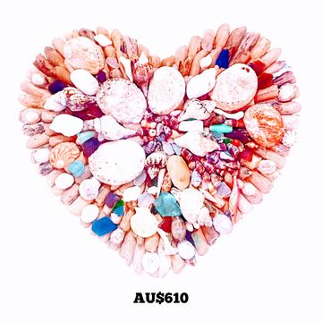 Heart-shaped arrangement of colorful seashells and stones.