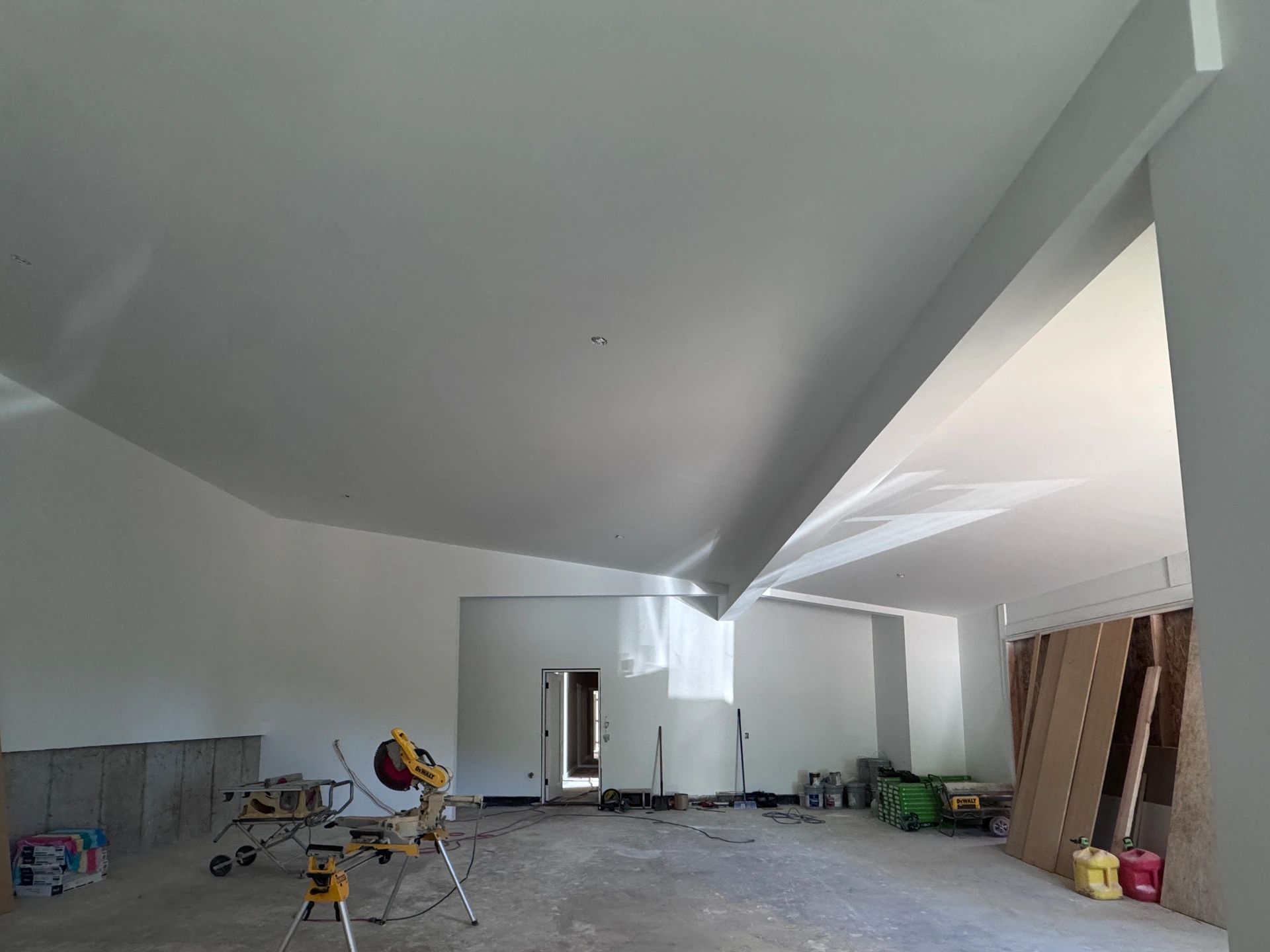 Interior of a room under construction with tools and materials scattered around.