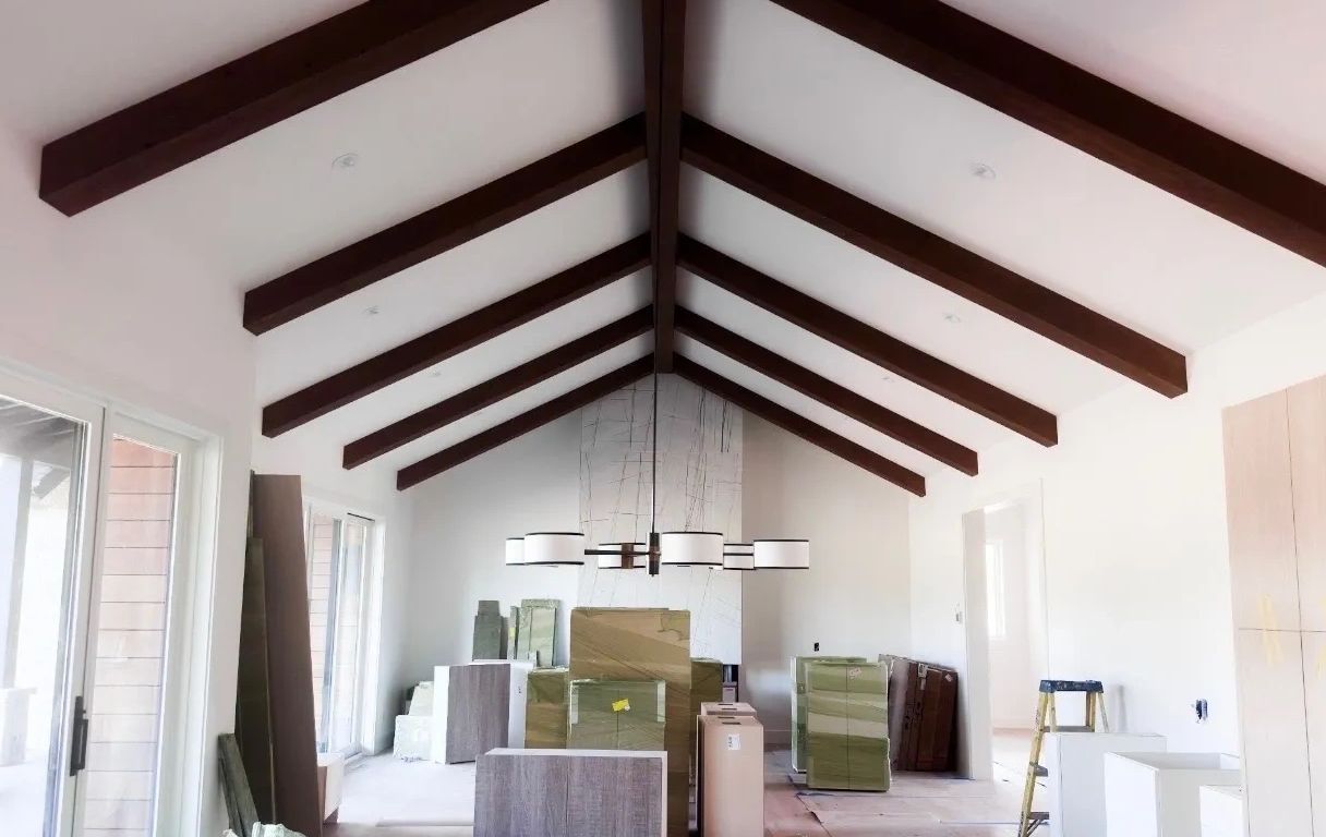 Clean modern home in RVR Carbondale featuring vaulted ceilings with exposed wood beams and custom li