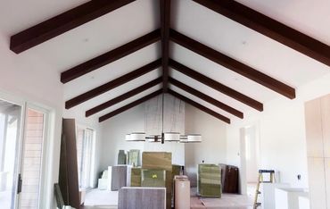 Clean modern home in RVR Carbondale featuring vaulted ceilings with exposed wood beams and custom li
