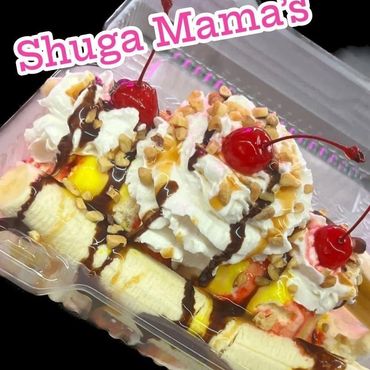 Banana split dessert with whipped cream, cherries, nuts, and chocolate drizzle.