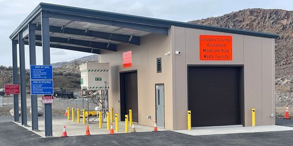 Facility building labeled Douglas County Household Moderate Risk Waste Facility.