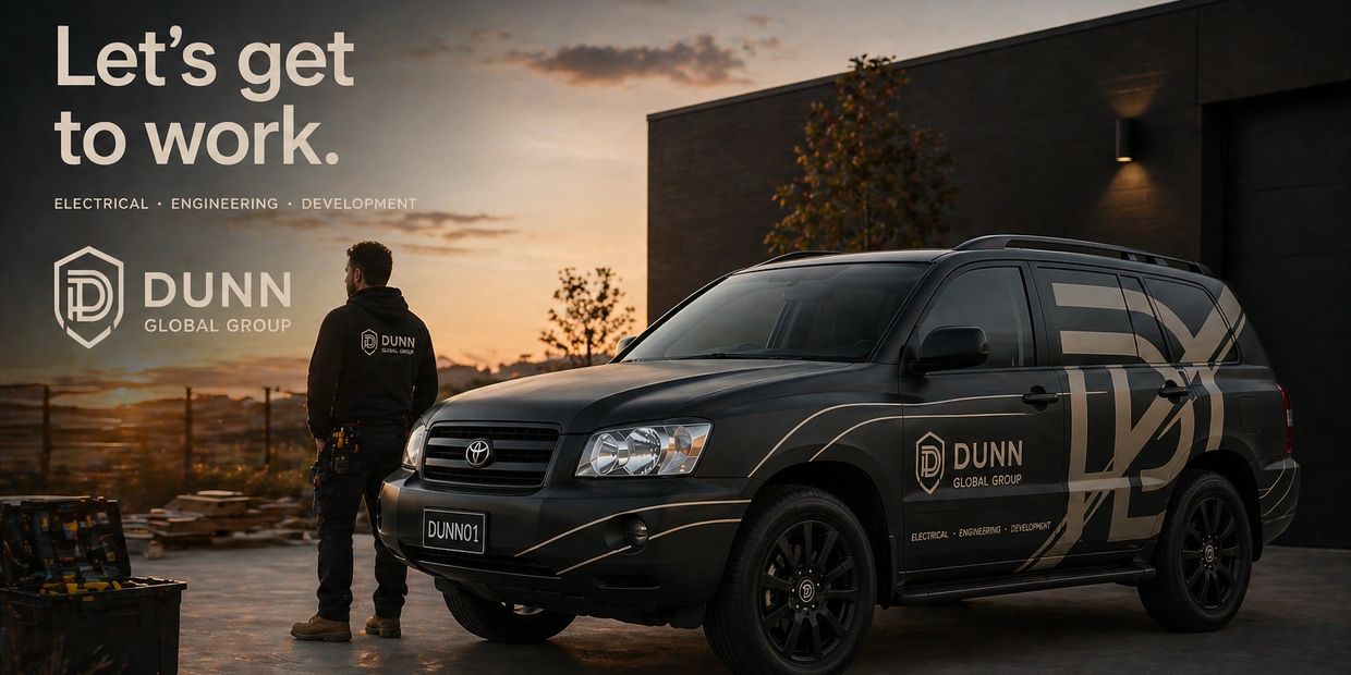 A worker and branded vehicle of Dunn Global Group at sunset.