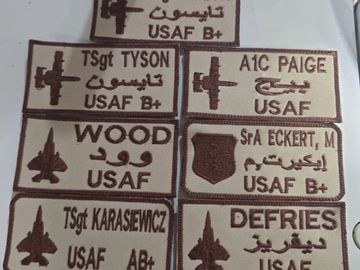 Military name patches with USAF and B+ blood type symbols.