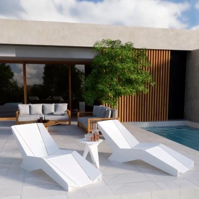 Modern outdoor lounge chairs next to a pool.