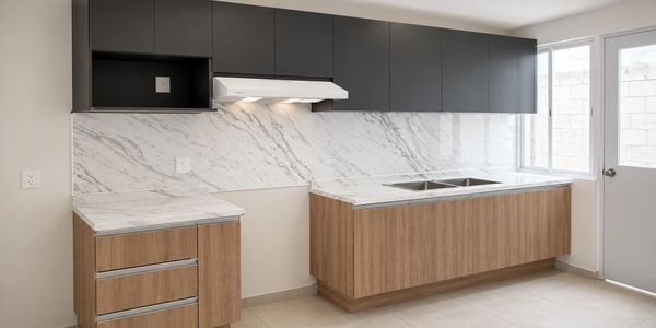 Modern kitchen with wood and black cabinets and marble countertops.
