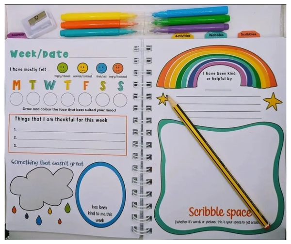 Journal open on a double page showing on of 52 weekly pages to be filled in daily. Colourful images d