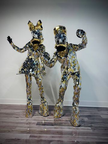 Shiny mirrored sculptures of Donald Duck and Daisy Duck.