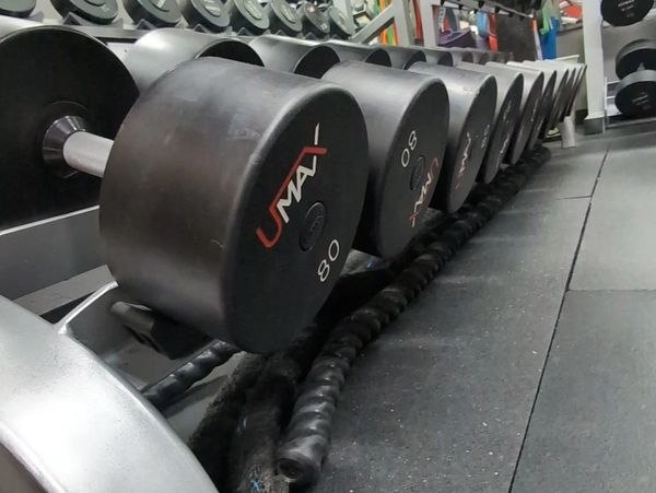 dumbbells and gym equipment for heavy weight strength training and getting out of chronic pain
