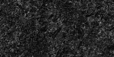 Close-up of a dark, textured granite surface with intricate patterns.
