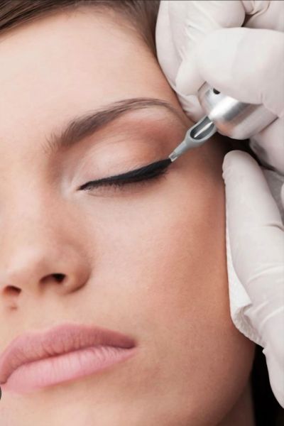 Close-up of permanent eyeliner application on a woman's eyelid.