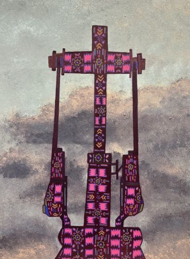 Colorful patterned guitar headstock against a cloudy sky.