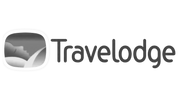 Travelodge logo with a sleeping figure and gradient background.