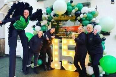 themed male stilt walker celebrating 15 years open in local town 