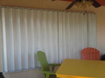 Accordion hurricane shutters
