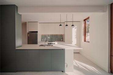 Modern kitchen with minimalist design and natural light.