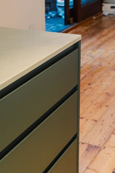 Close-up of a cabinet corner and wooden floor.