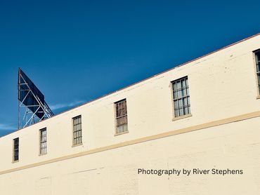 A building with multiple windows under a clear blue sky.