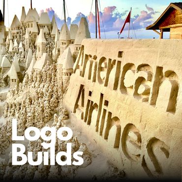 Detailed sandcastle with 'American Airlines' carved in sand.