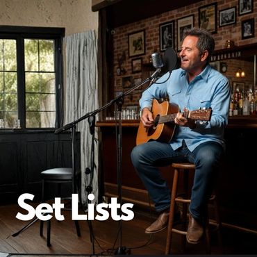 Man playing guitar and singing in a cozy bar setting.