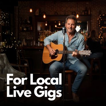 Man playing guitar live in a cozy bar setting.