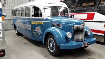 Vintage blue and white bus labeled 'Pioneer Tours'.