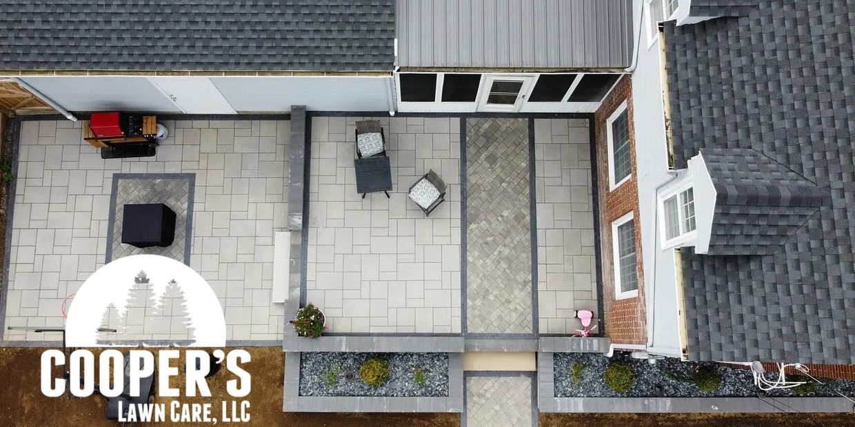 Aerial view of a well-designed patio with seating and a grill, showcasing landscaping by Cooper's Lawn Care, LLC.