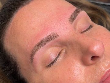 Close-up of freshly microbladed eyebrows.