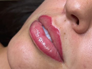 Close-up of lips with red lip liner.