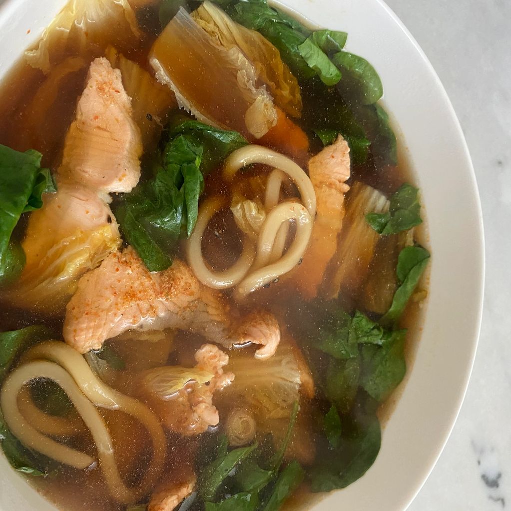 shabu shabu soup with salmon spinach cabbage and udon noodles